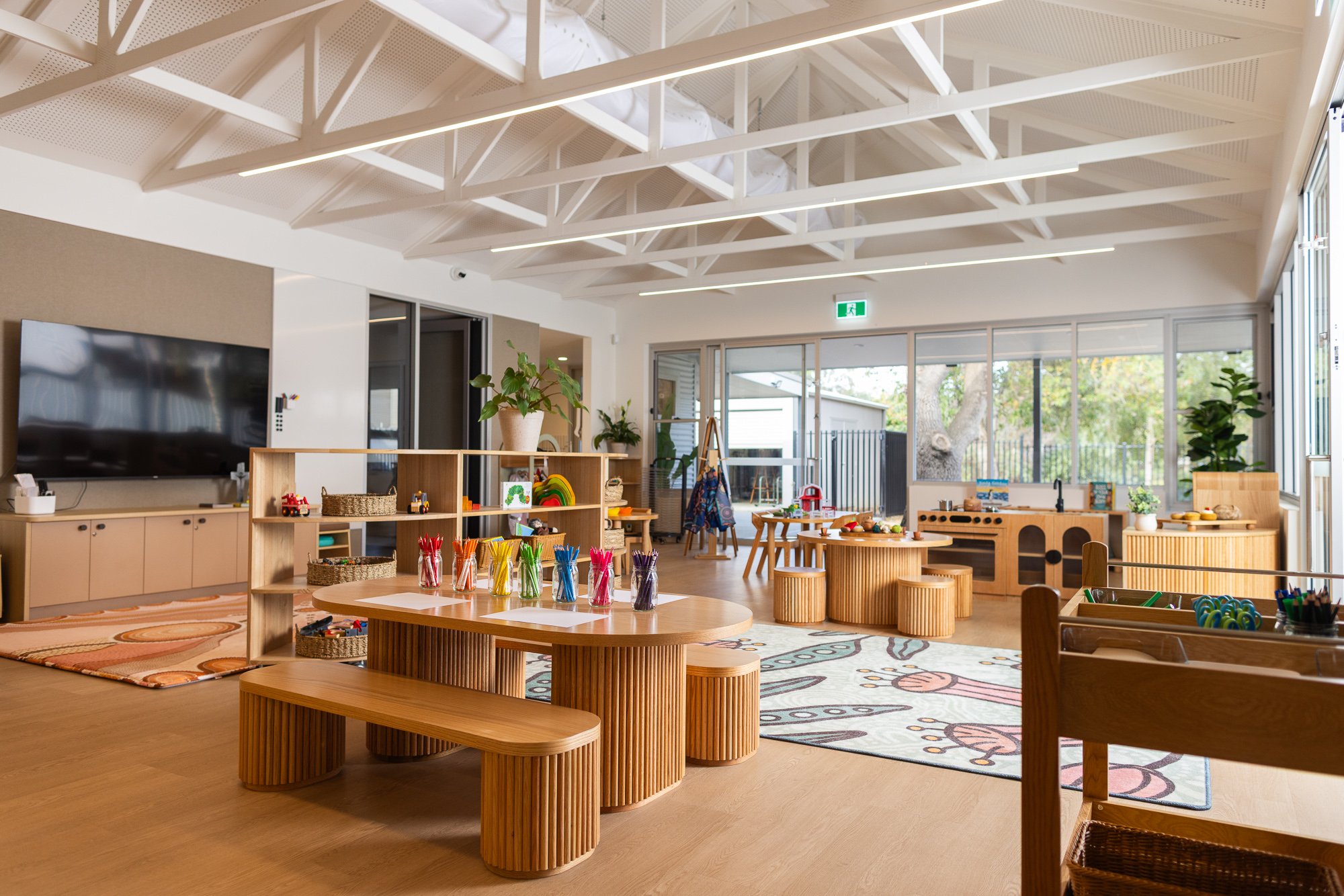 Modern St Michael’s Early Learning Centre classroom with child-friendly tables, learning areas, play equipment, and natural light.